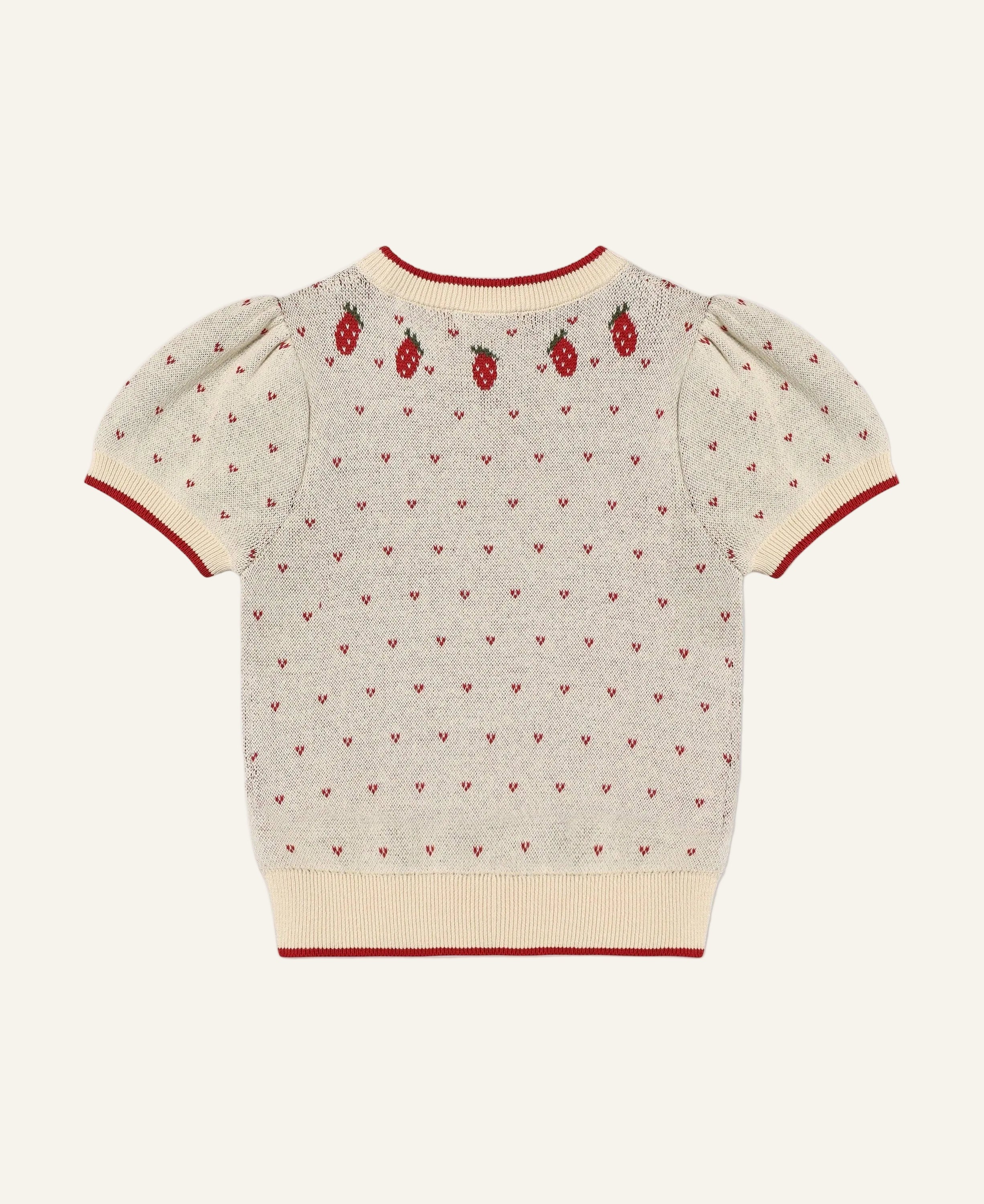 A cream-colored short-sleeve knit sweater with red trim, featuring a pattern of tiny red hearts and three embroidered red strawberries on the upper back, shown against a light gray background.