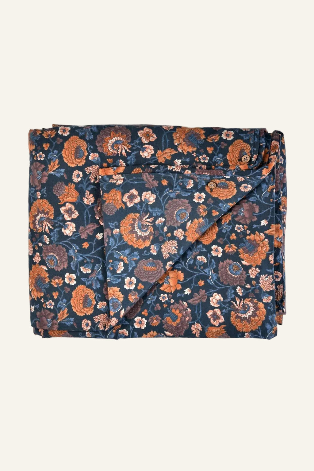 Folded floral blanket with orange and pink flowers on a blue background