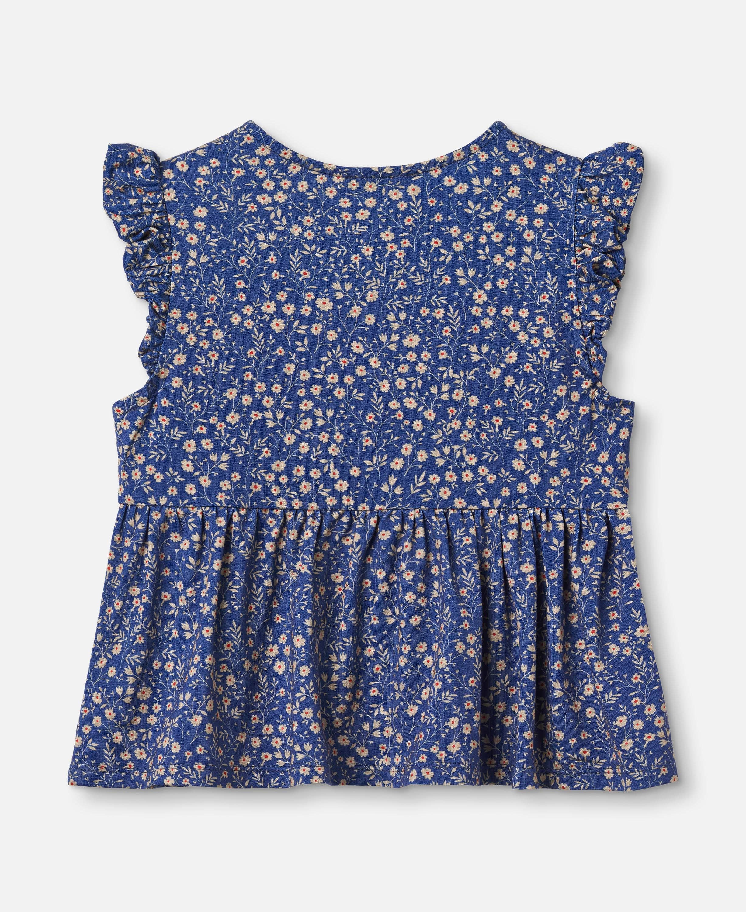 A sleeveless blue children's top with a dense small floral print in beige and white, featuring ruffled cap sleeves and a gathered peplum hem, shown flat against a light gray background.