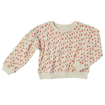 A long-sleeve crewneck sweatshirt featuring an all-over repeating pattern of small red and green leaf-like motifs on a warm cream background.