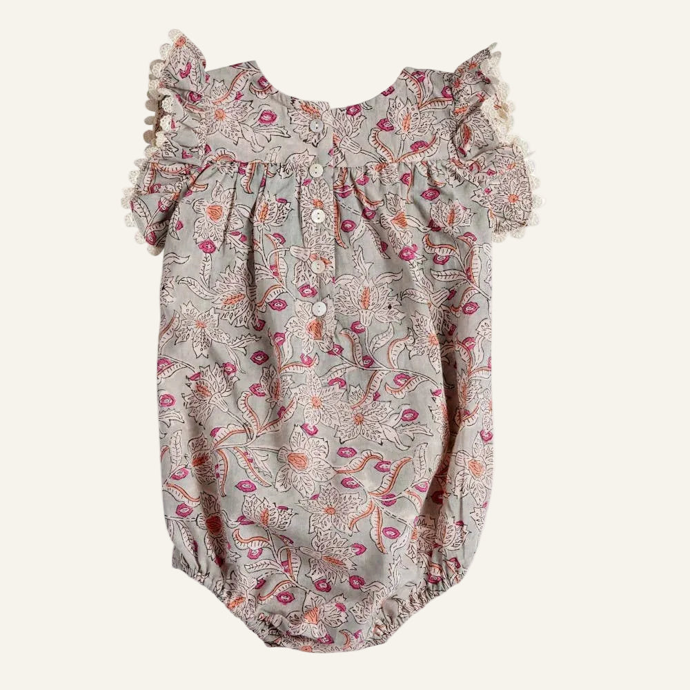Floral baby romper with ruffled sleeves on a white background