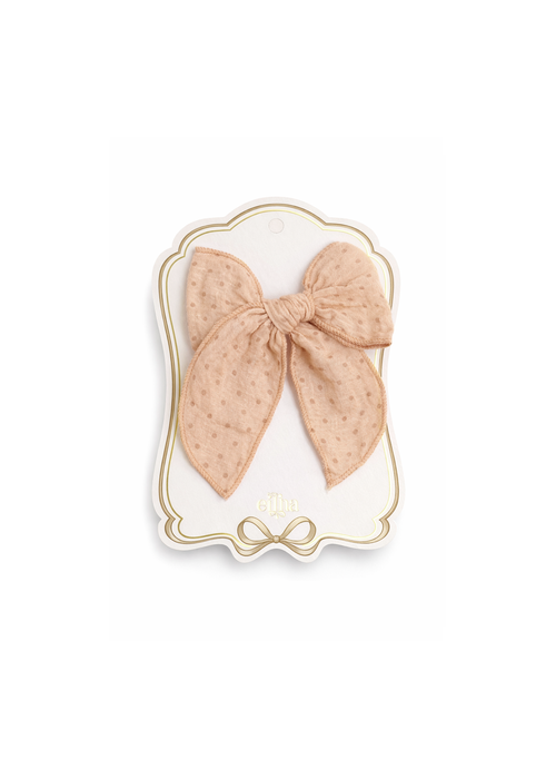 A beige sheer bow with tiny embroidered floral details, displayed on a decorative white and gold card featuring the brand name 'ella'.