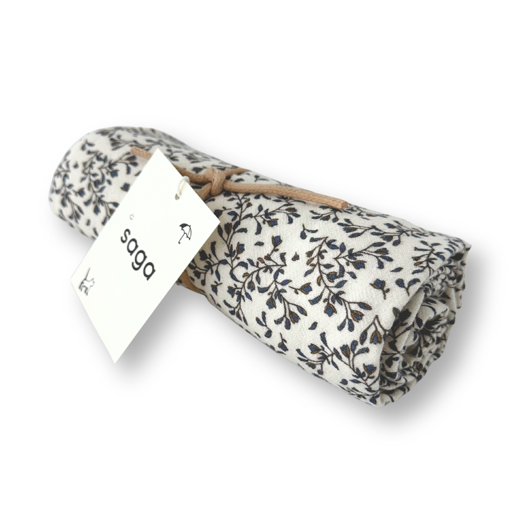 Folded fabric with floral pattern and 'saga' label on a white background