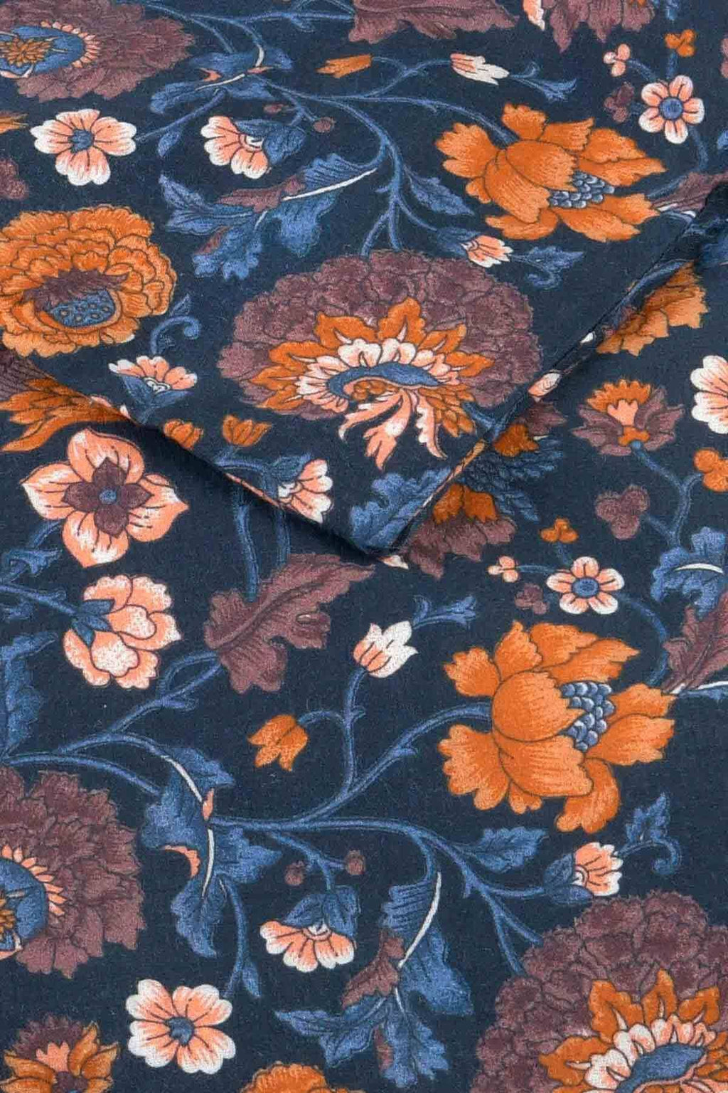 Floral patterned fabric with orange, purple, and pink flowers on a dark blue background