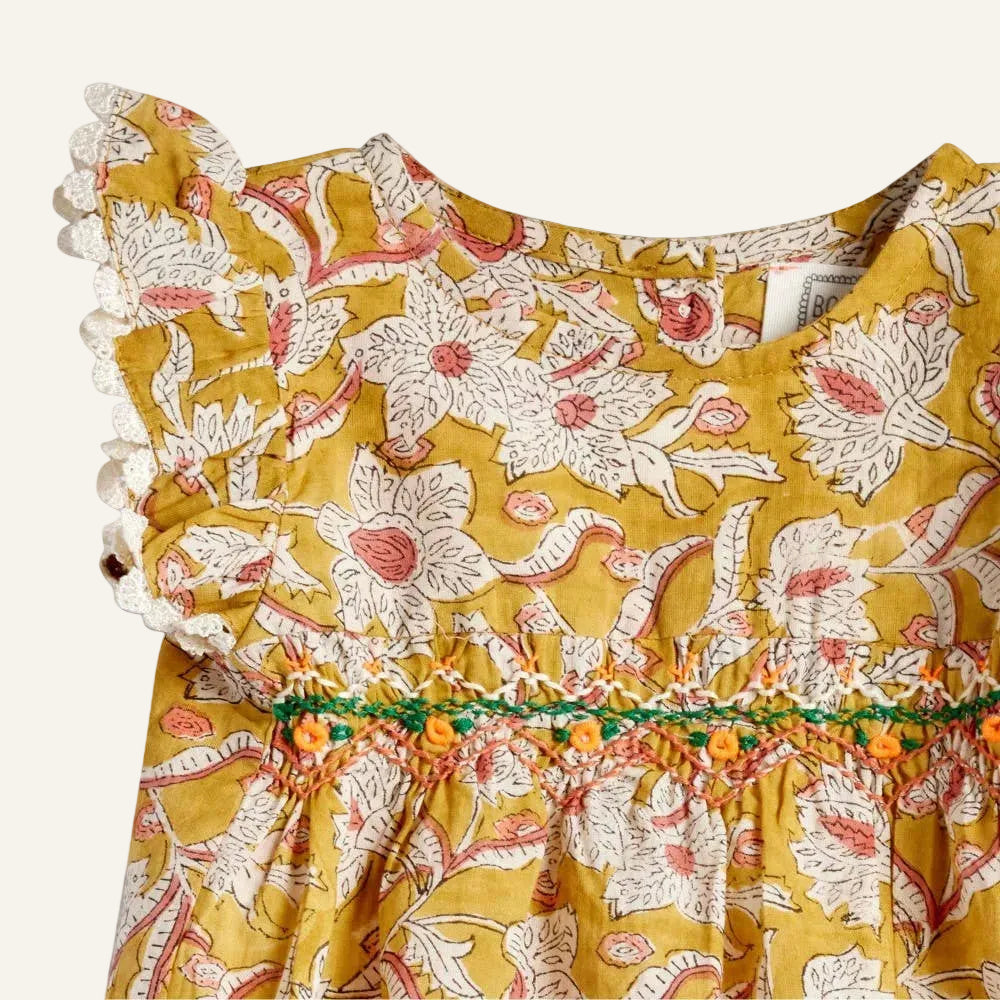 Yellow floral dress with ruffled sleeves on a white background