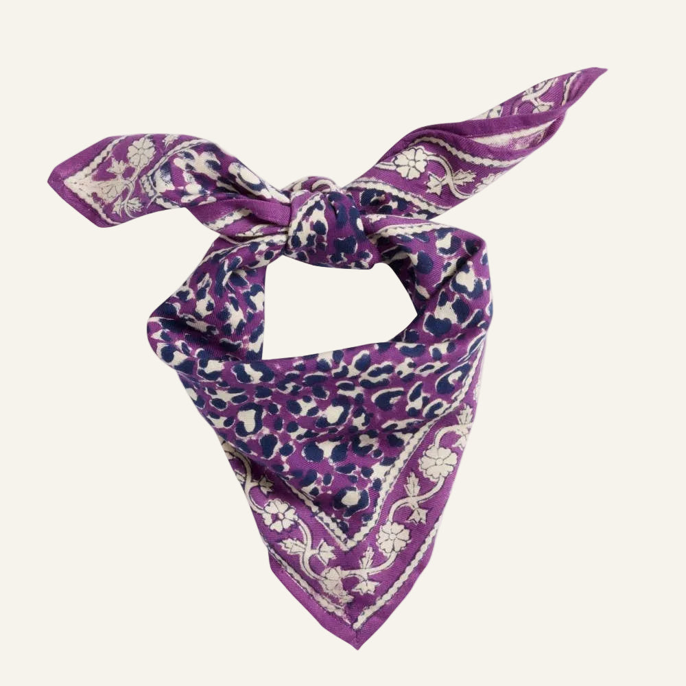 Purple bandana with white floral pattern on a white background