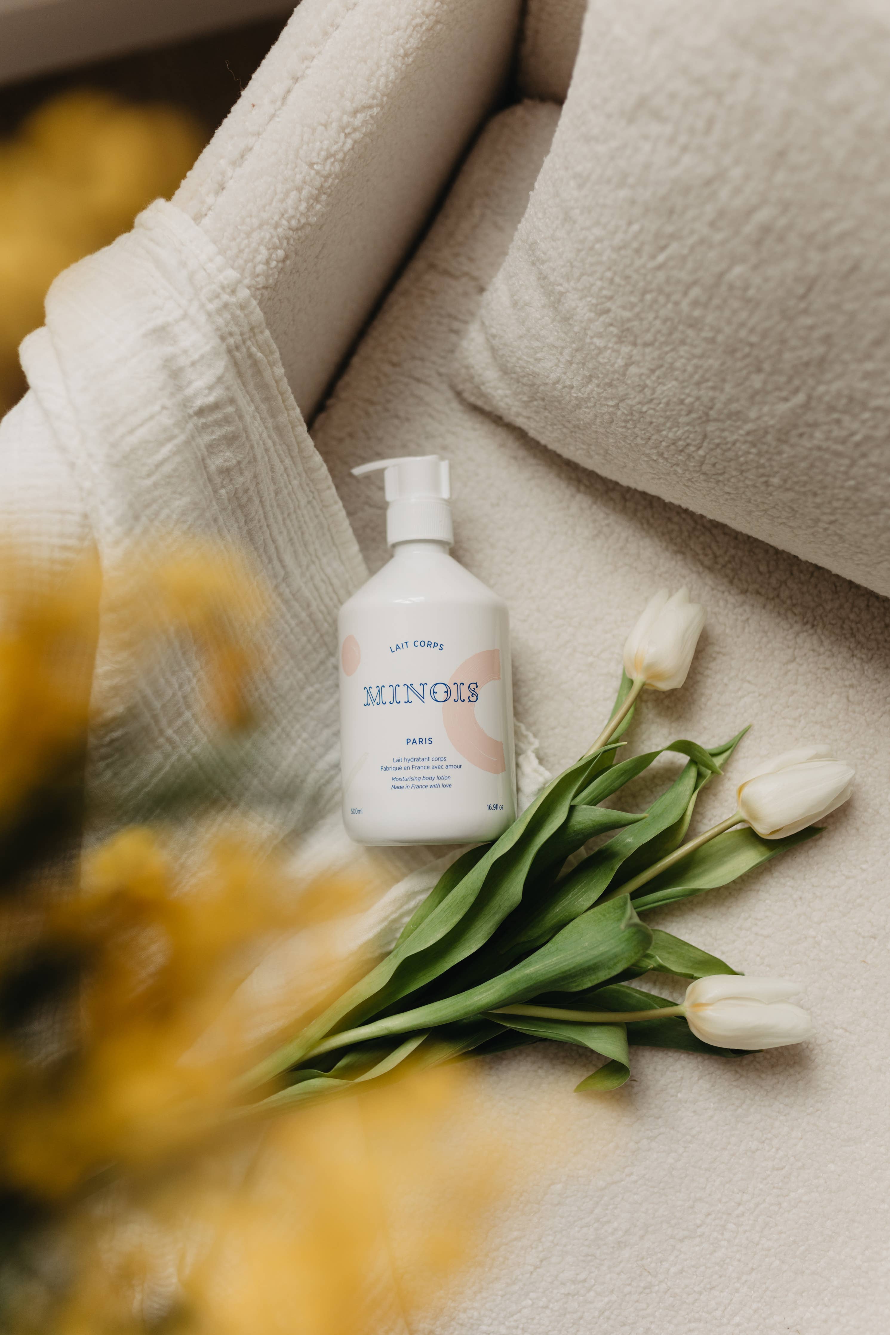 Minois bottle on a couch with tulips