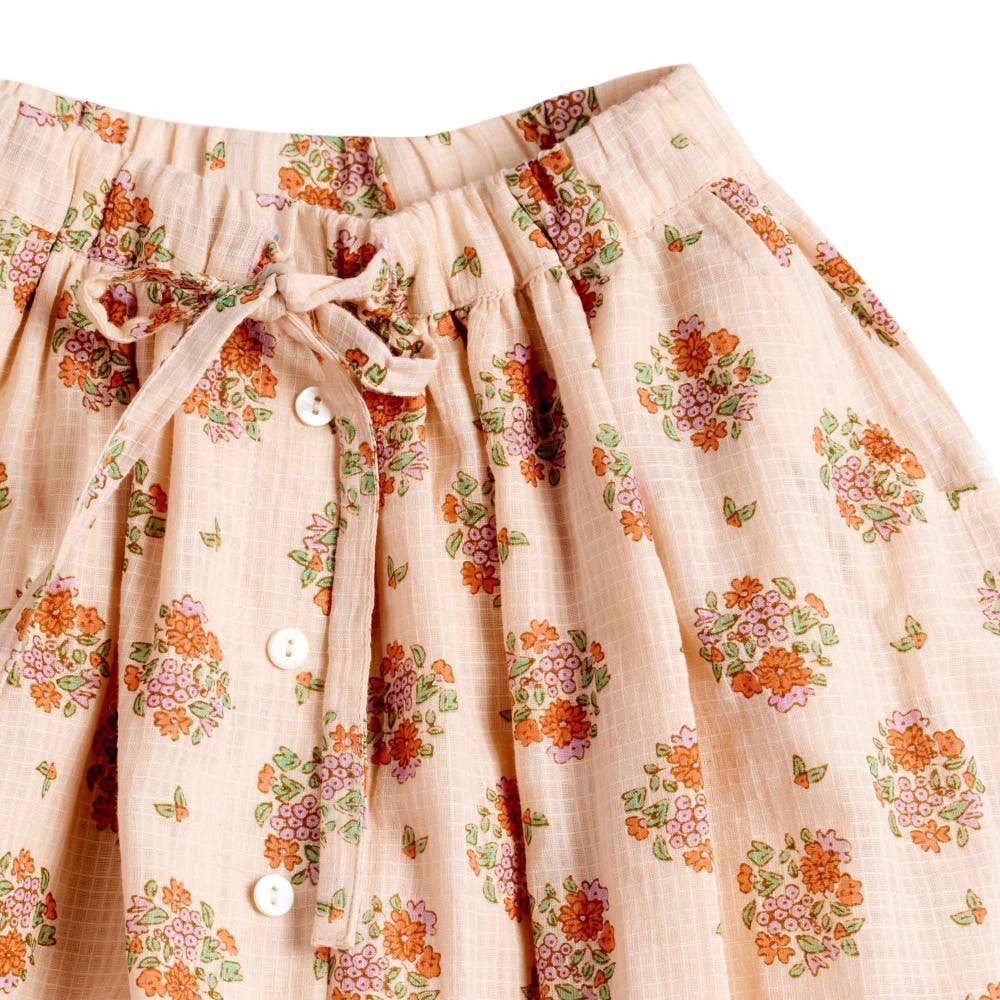 Floral patterned fabric with buttons on a beige background