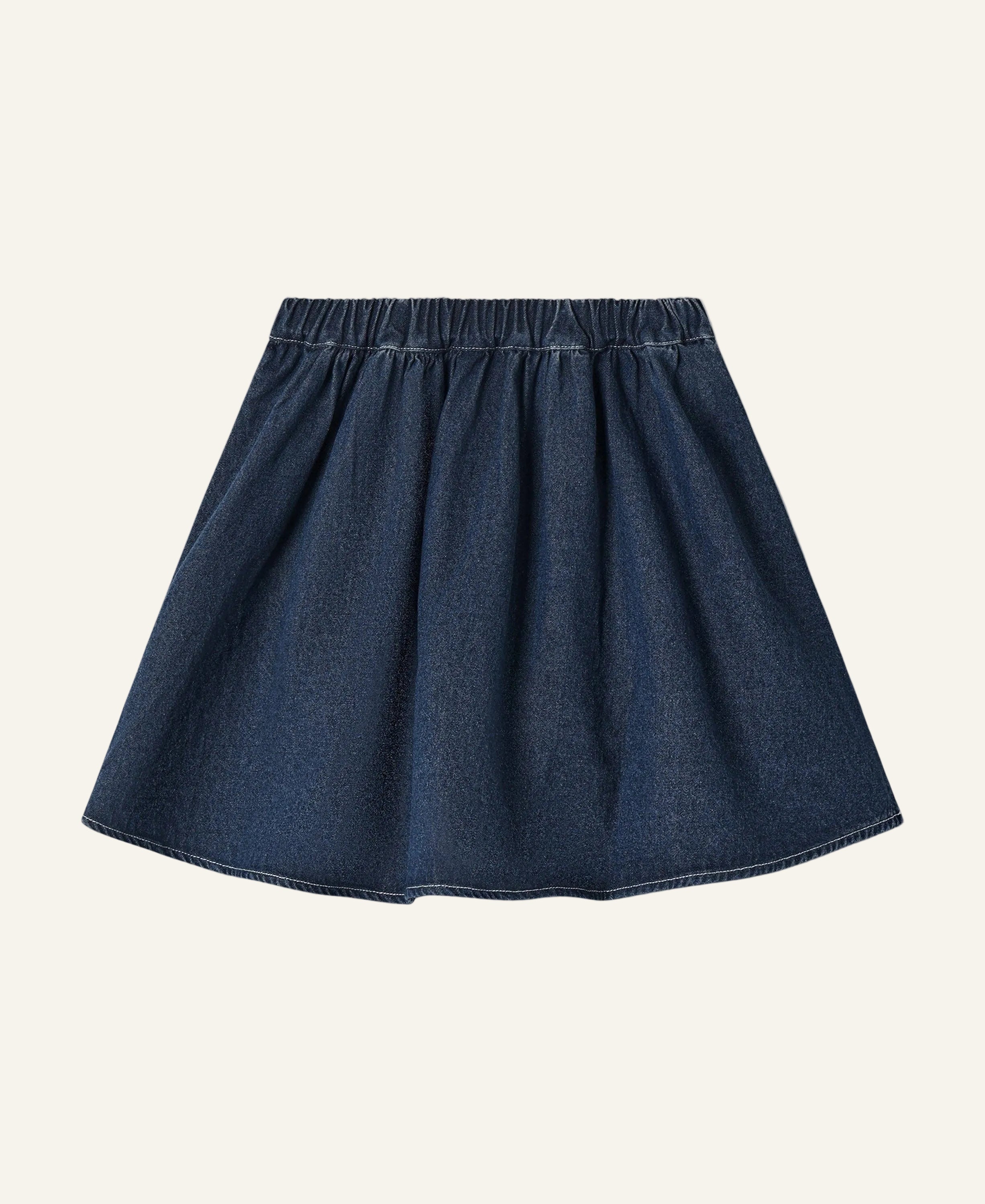 A dark blue denim A-line skirt with an elastic waistband, shown flat against a light cream background.