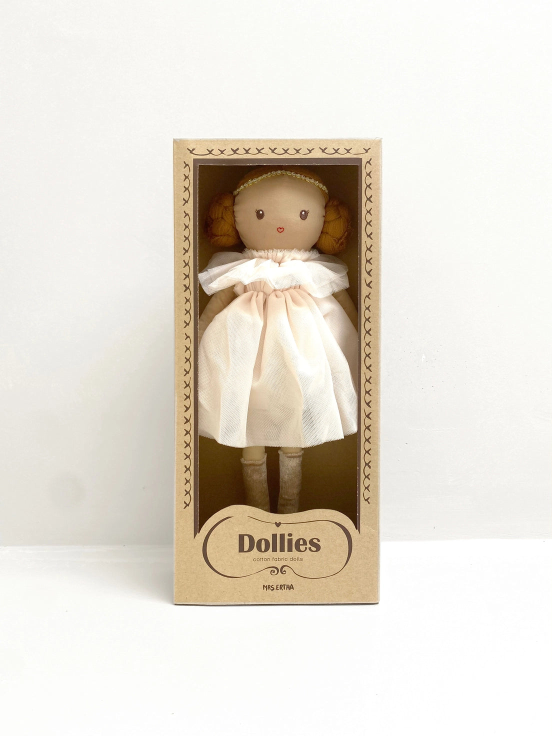 Toy doll in a cardboard box with 'Dollies' branding on a white background