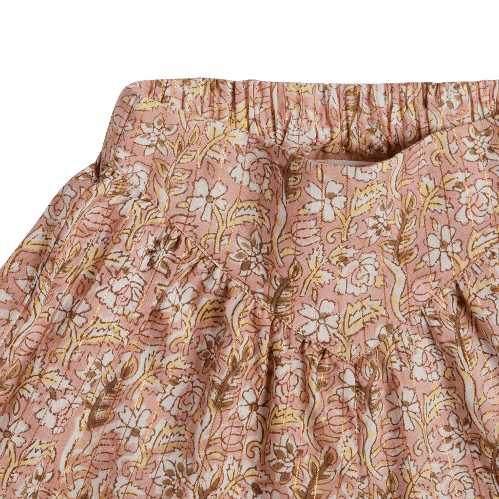 Close-up of a pink floral patterned fabric with a green background