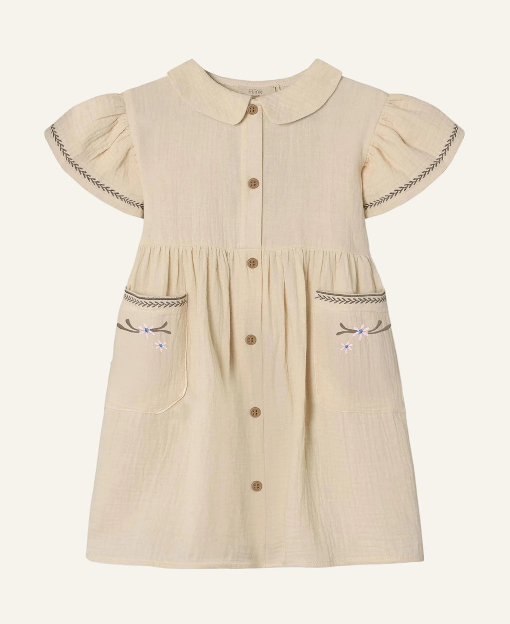 A cream-colored cotton gauze dress for toddlers, featuring a Peter Pan collar, short flutter sleeves with decorative stitching, a button-up front, and embroidered bow details on the front pockets.