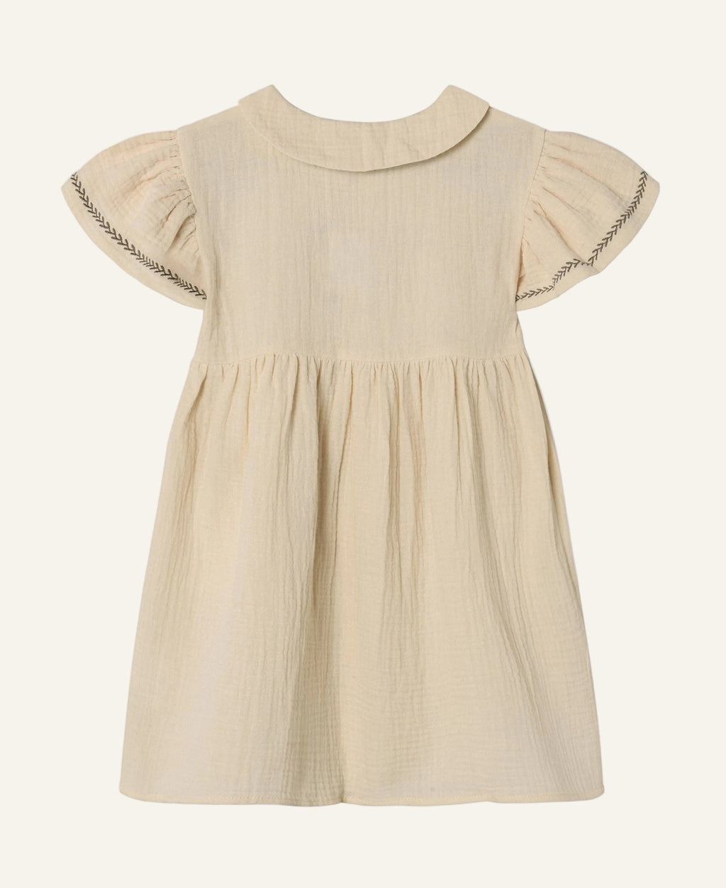 A light beige cotton gauze dress for toddlers, featuring a Peter Pan collar, short flutter sleeves with decorative zigzag stitching, and a gathered waist.