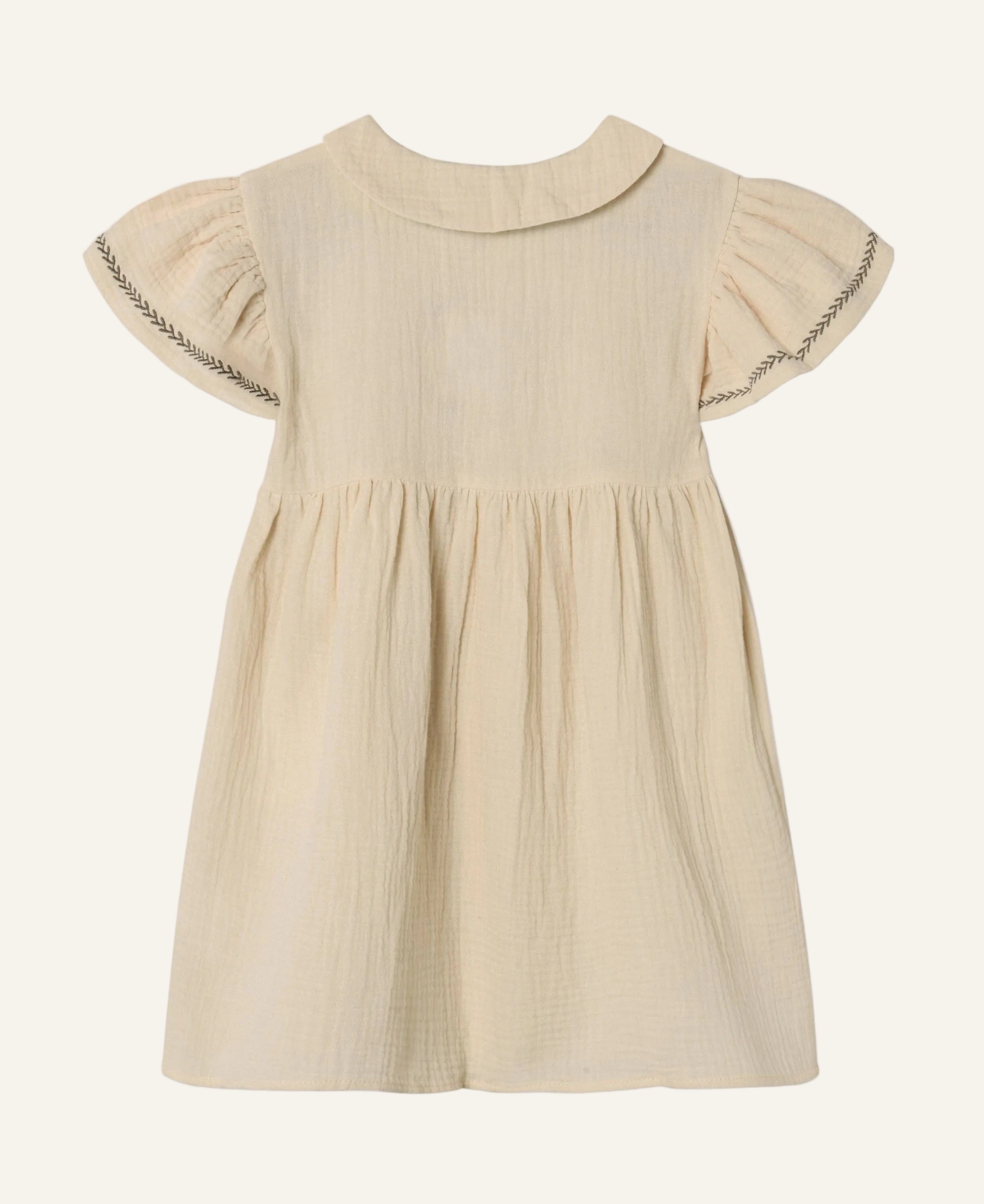 A light beige cotton gauze dress for toddlers, featuring a Peter Pan collar, short flutter sleeves with decorative zigzag stitching, and a gathered waist.