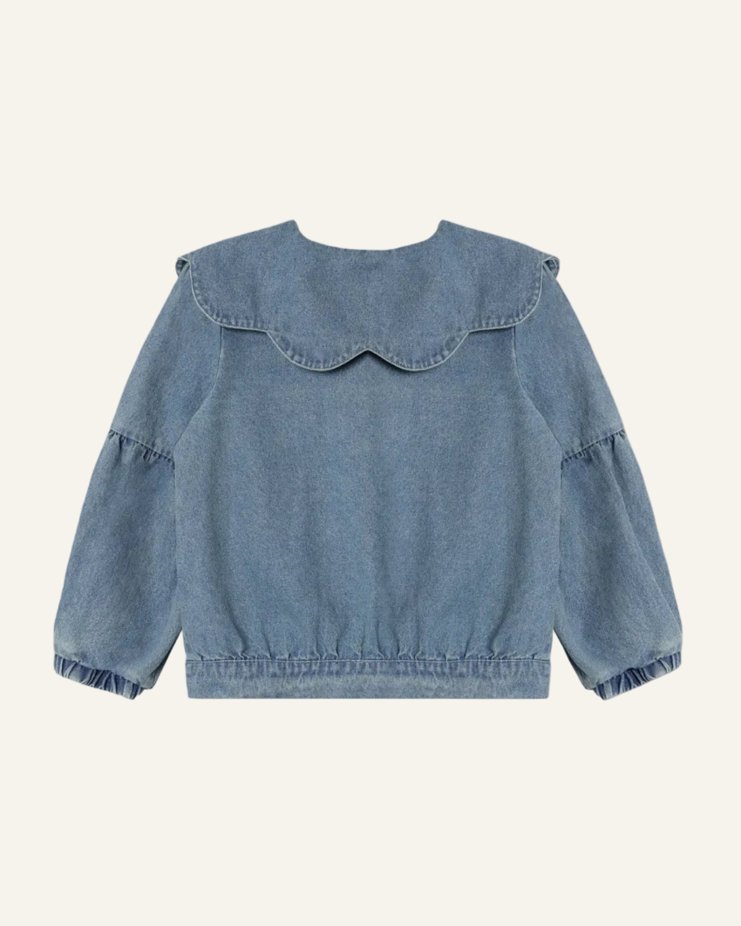 A light blue denim long-sleeve top with a large scalloped Peter Pan collar and ruffled cuffs, shown flat against a light gray background.