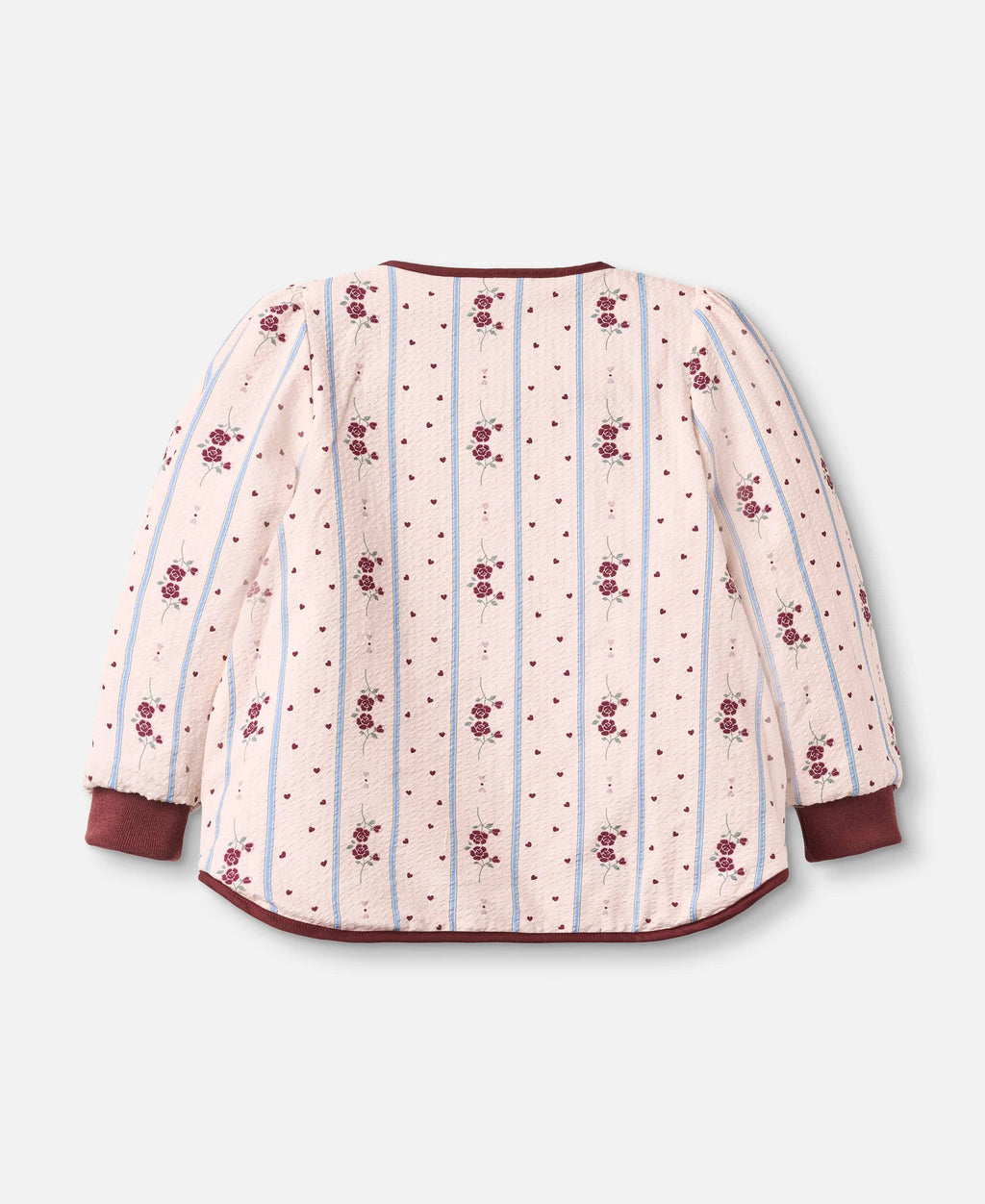 A long-sleeve quilted jacket with a cream-colored body, decorated with vertical light blue stripes, small red polka dots, and repeating red floral motifs. It features solid dark red cuffs and a matching dark red curved hem, shown against a light gray background.