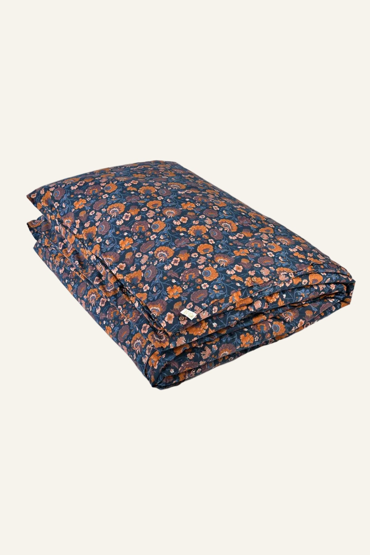 Folded floral-patterned blanket on a white background