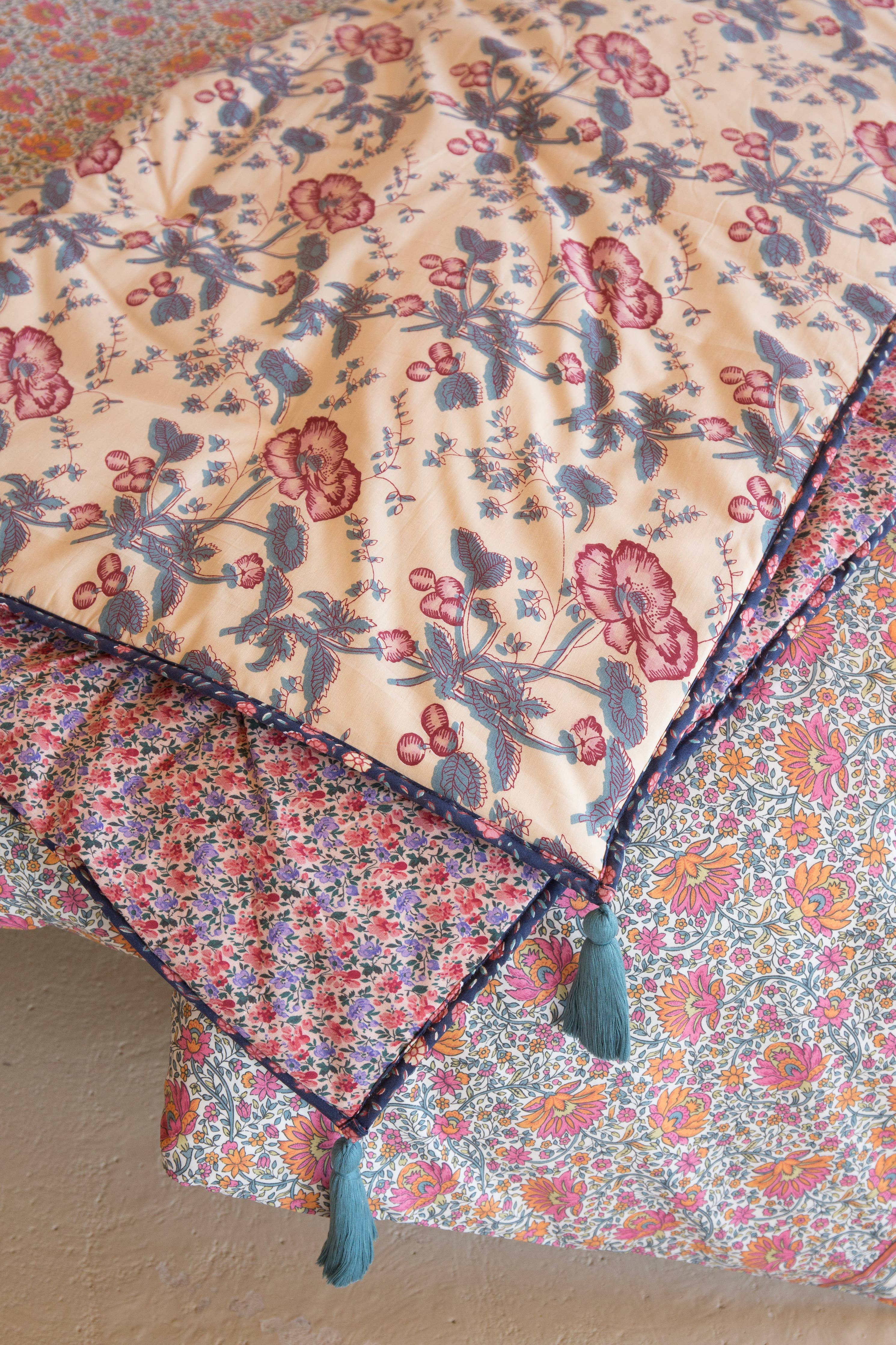 Floral patterned fabric with a visible brand name on a beige surface