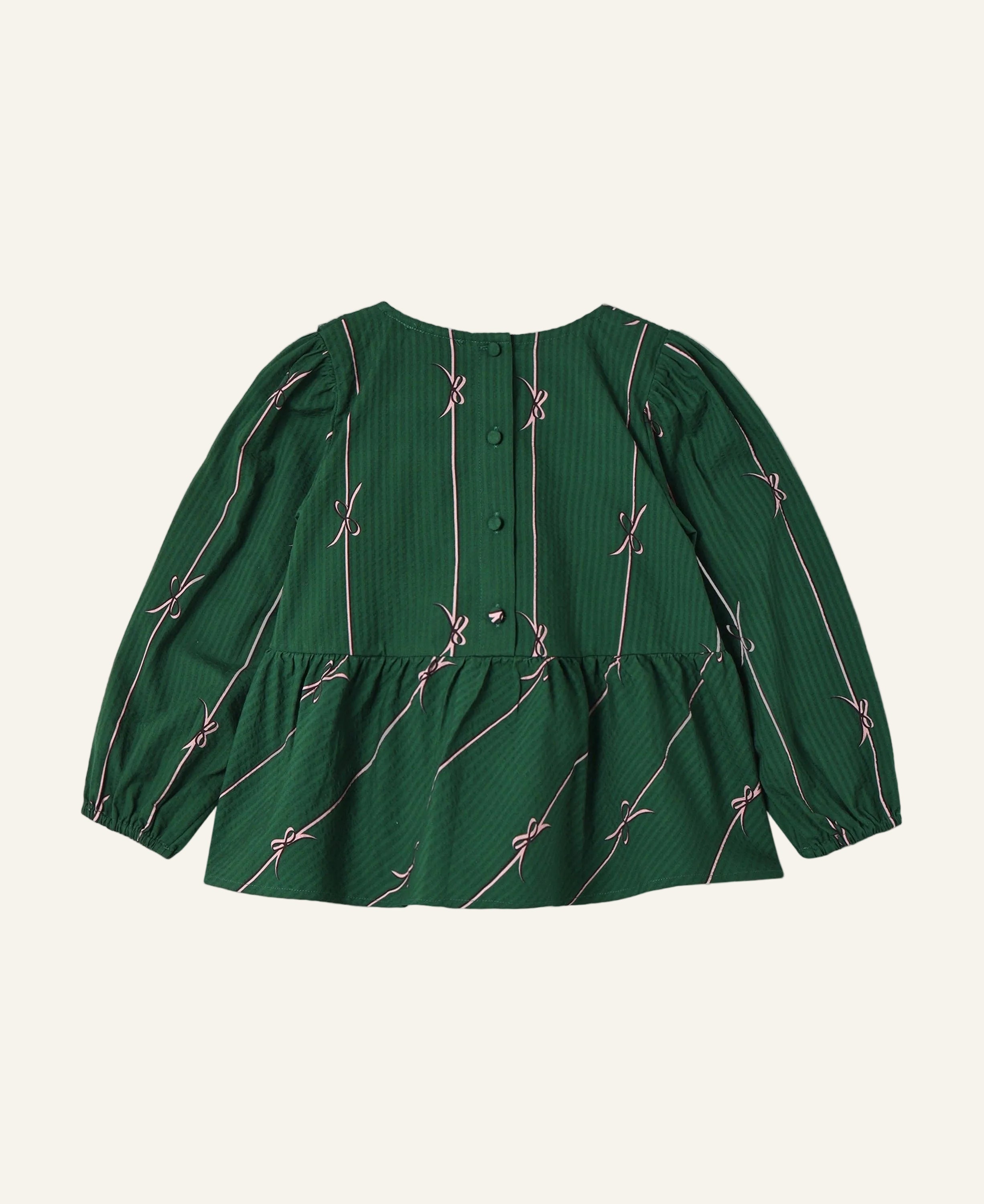 A green long-sleeve blouse with a textured vertical stripe pattern and thin pink diagonal lines with bow motifs, shown from the back on a light gray background.
