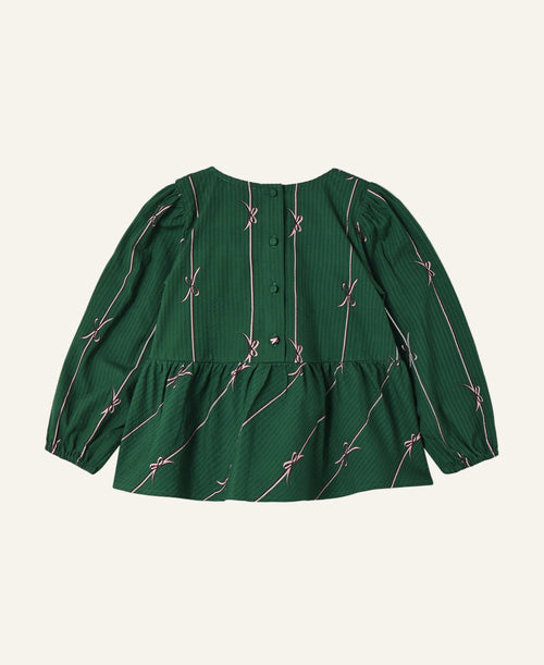 A green long-sleeve blouse with a textured vertical stripe pattern and thin pink diagonal lines with bow motifs, shown from the back on a light gray background.