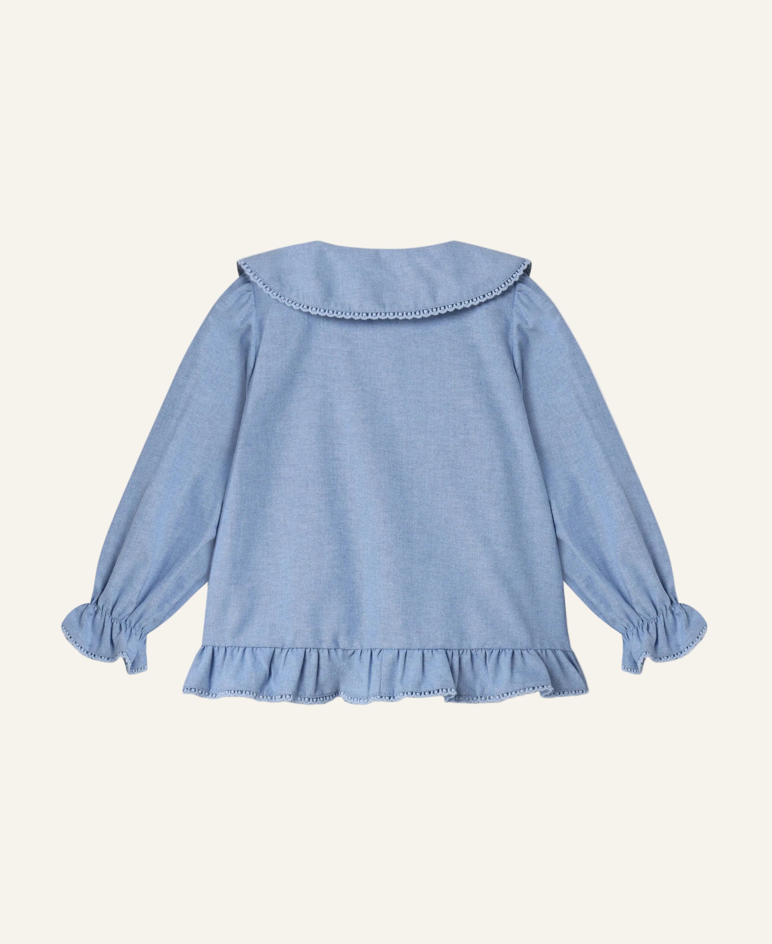 A light blue long-sleeve blouse for a toddler, shown from the back. The blouse features a wide collar with delicate bead trim, gathered long sleeves with ruffled cuffs, and a ruffled hem.