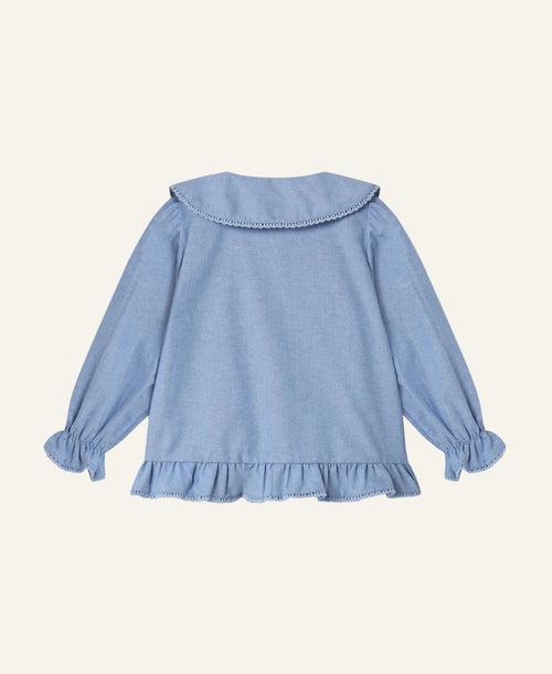 A light blue long-sleeve blouse for a toddler, shown from the back. The blouse features a wide collar with delicate bead trim, gathered long sleeves with ruffled cuffs, and a ruffled hem.