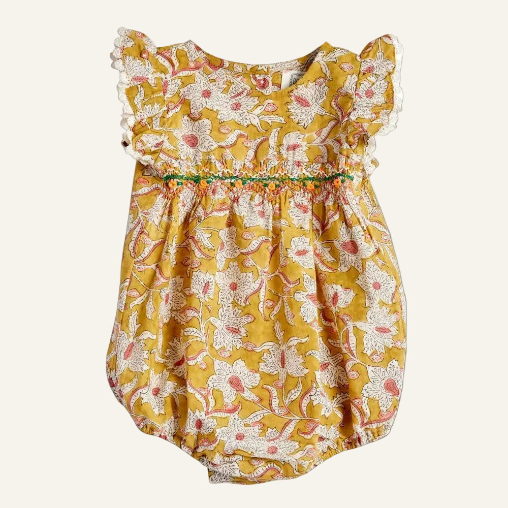 Yellow floral baby romper on a white background
