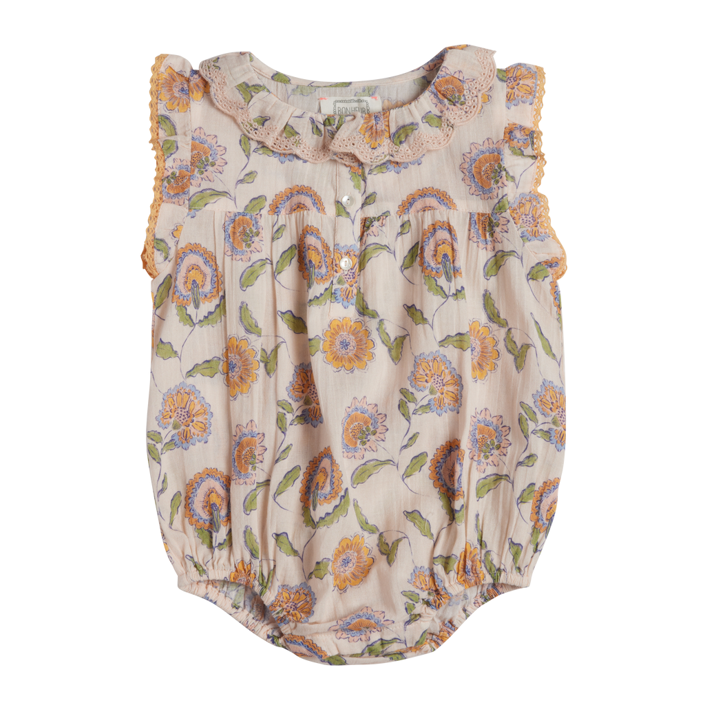 Floral-patterned baby romper on a white background