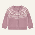 A pink knit cardigan sweater with a cream-colored Fair Isle pattern featuring hearts and snowflakes, displayed on a clean white background.