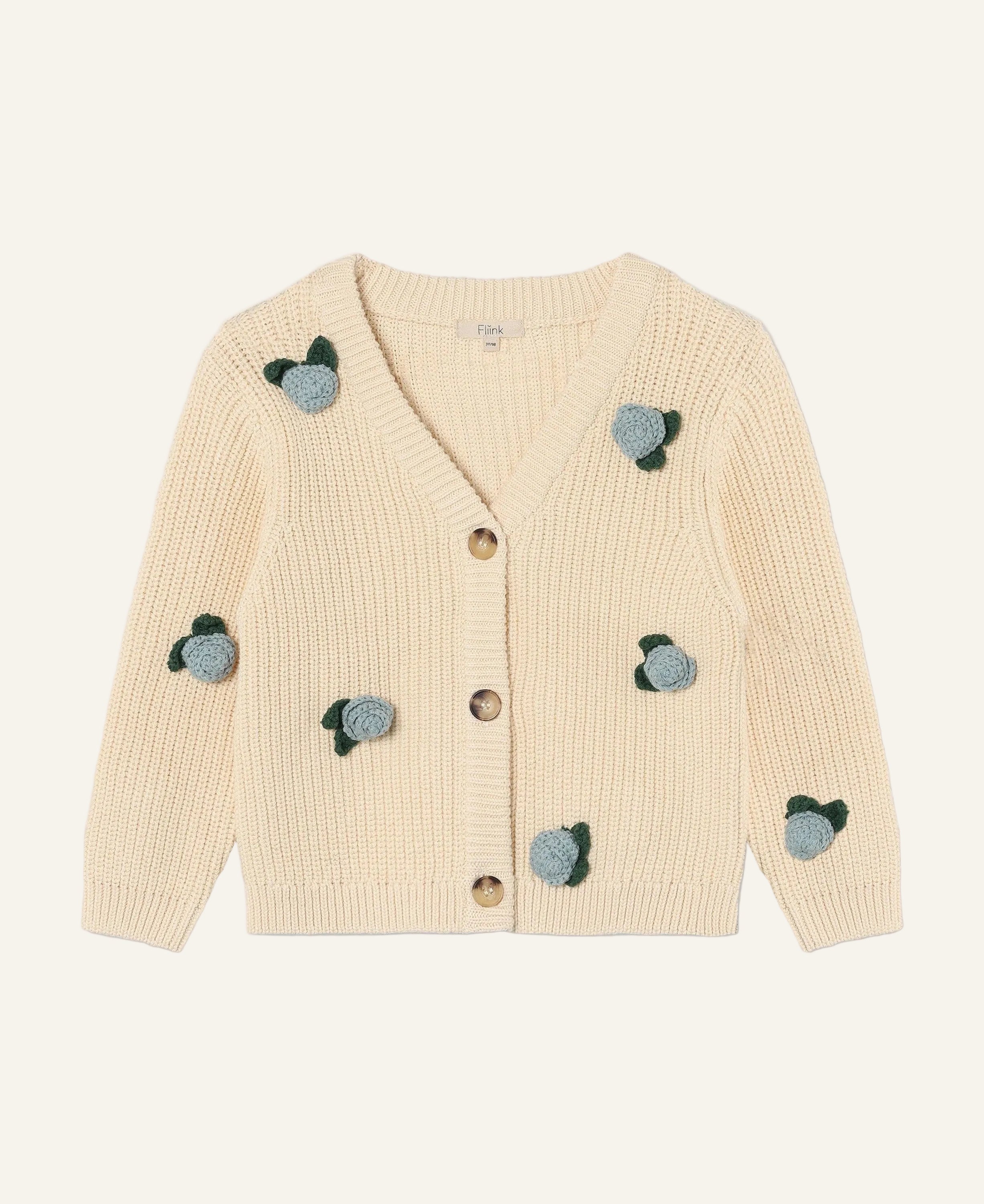 A cream-colored ribbed knit cardigan sweater with decorative blue and green embroidered motifs, shown flat on a light gray background.