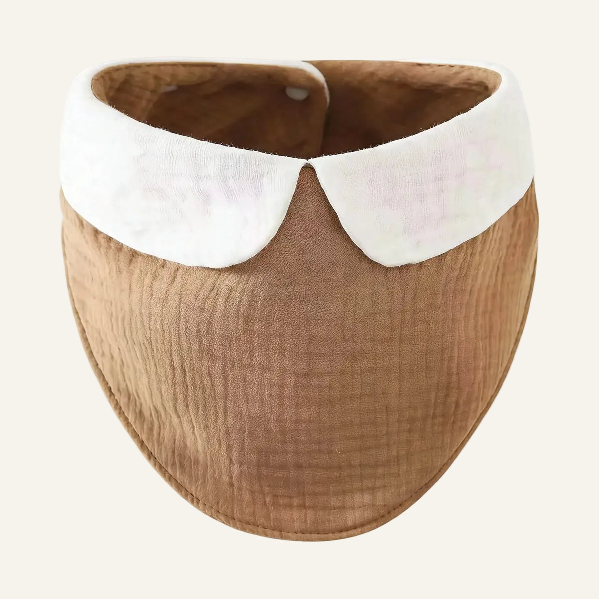 A baby bib with a textured tan body and a contrasting white Peter Pan collar, shown against a plain white background.