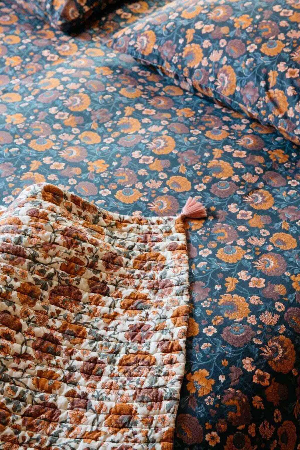 Floral patterned bedding with a focus on texture and color.