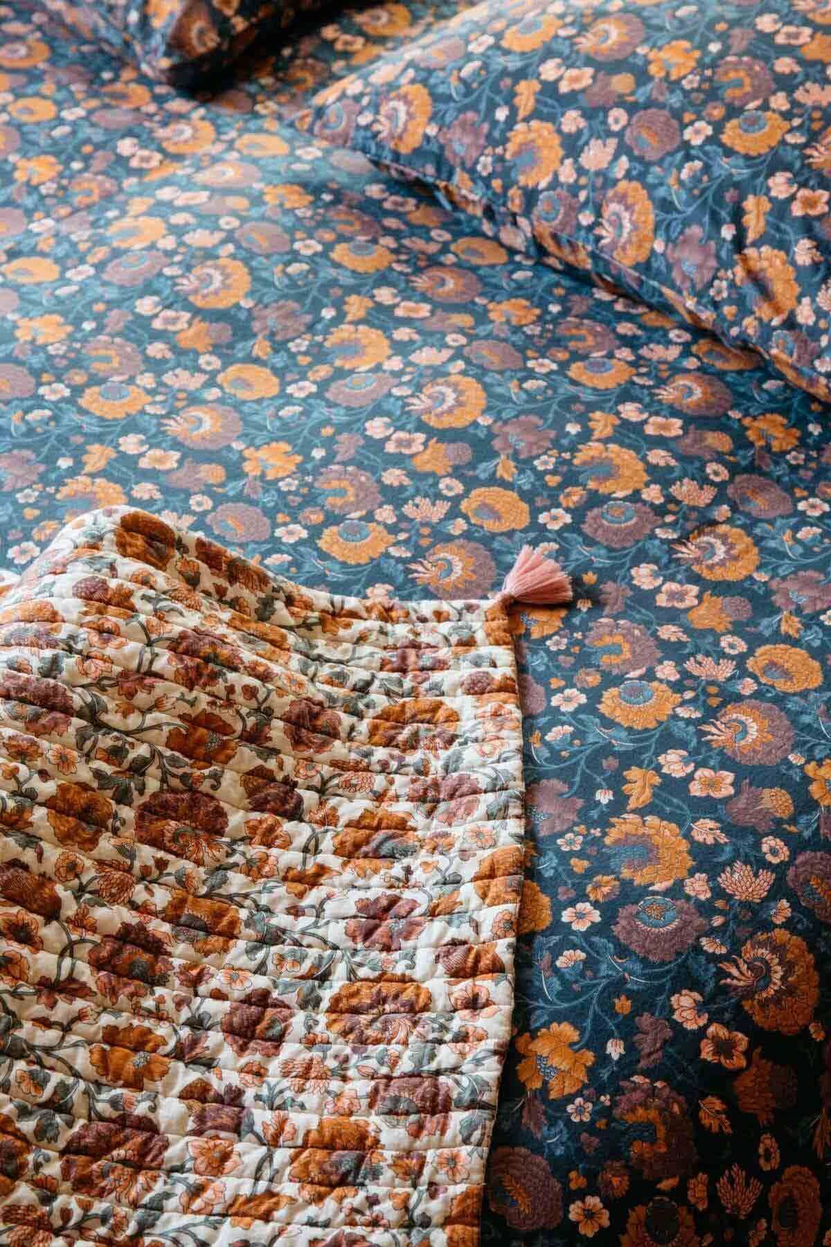 Floral patterned bedding with a focus on texture and color.