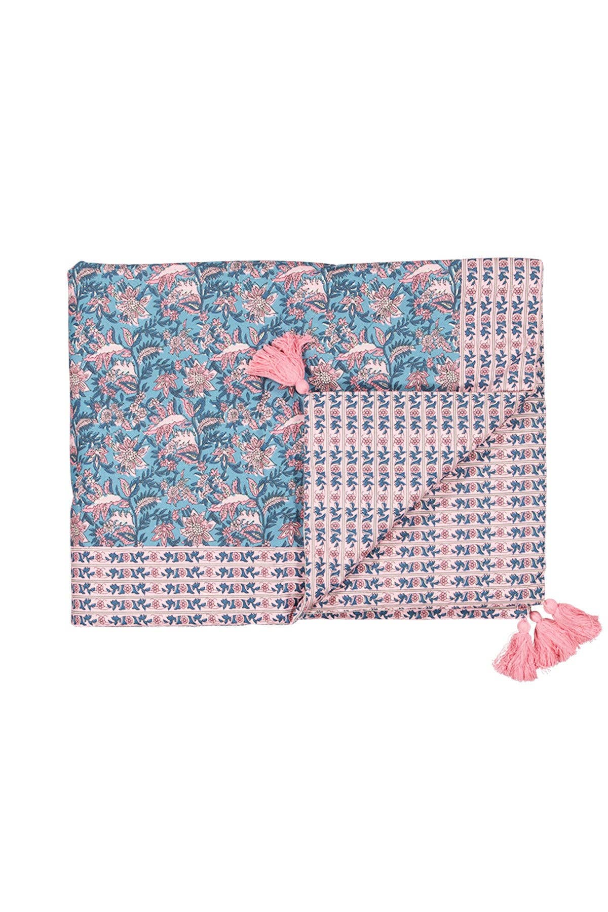Floral patterned blanket with pink tassels on a white background