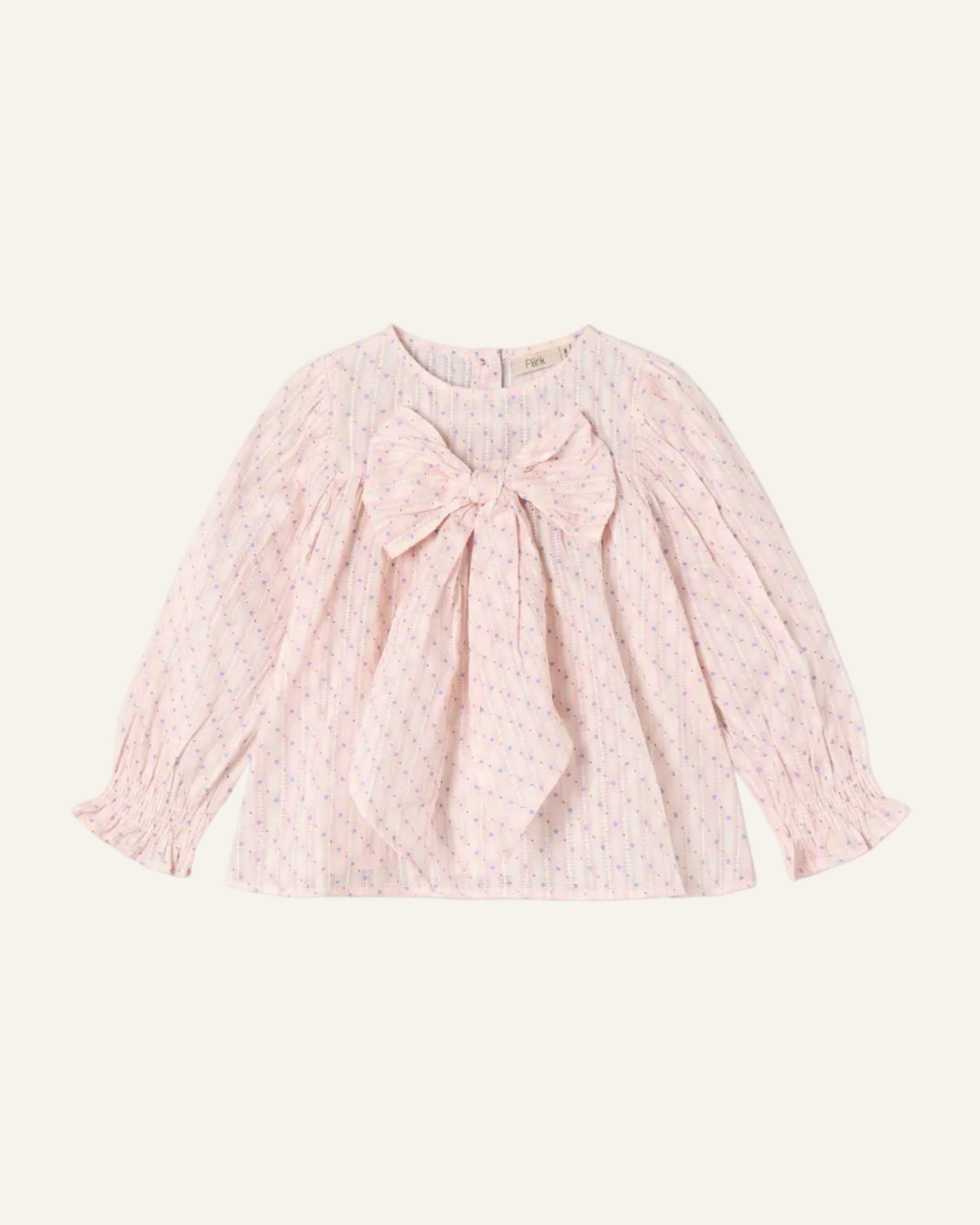 Pink blouse with a large bow on a light gray background