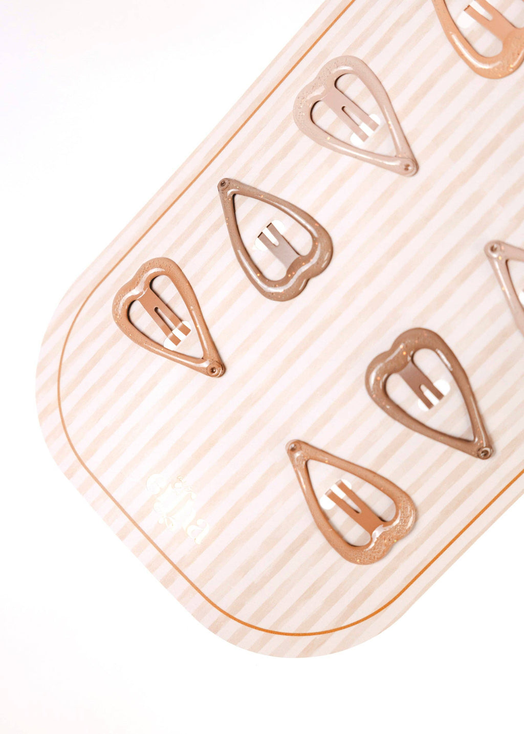 Close-up of a hair clip with a heart design on a white background