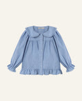 A light blue long-sleeve blouse for toddlers, featuring a large Peter Pan collar, button-up front, and ruffled trim at the hem and cuffs, shown flat on a light gray background.