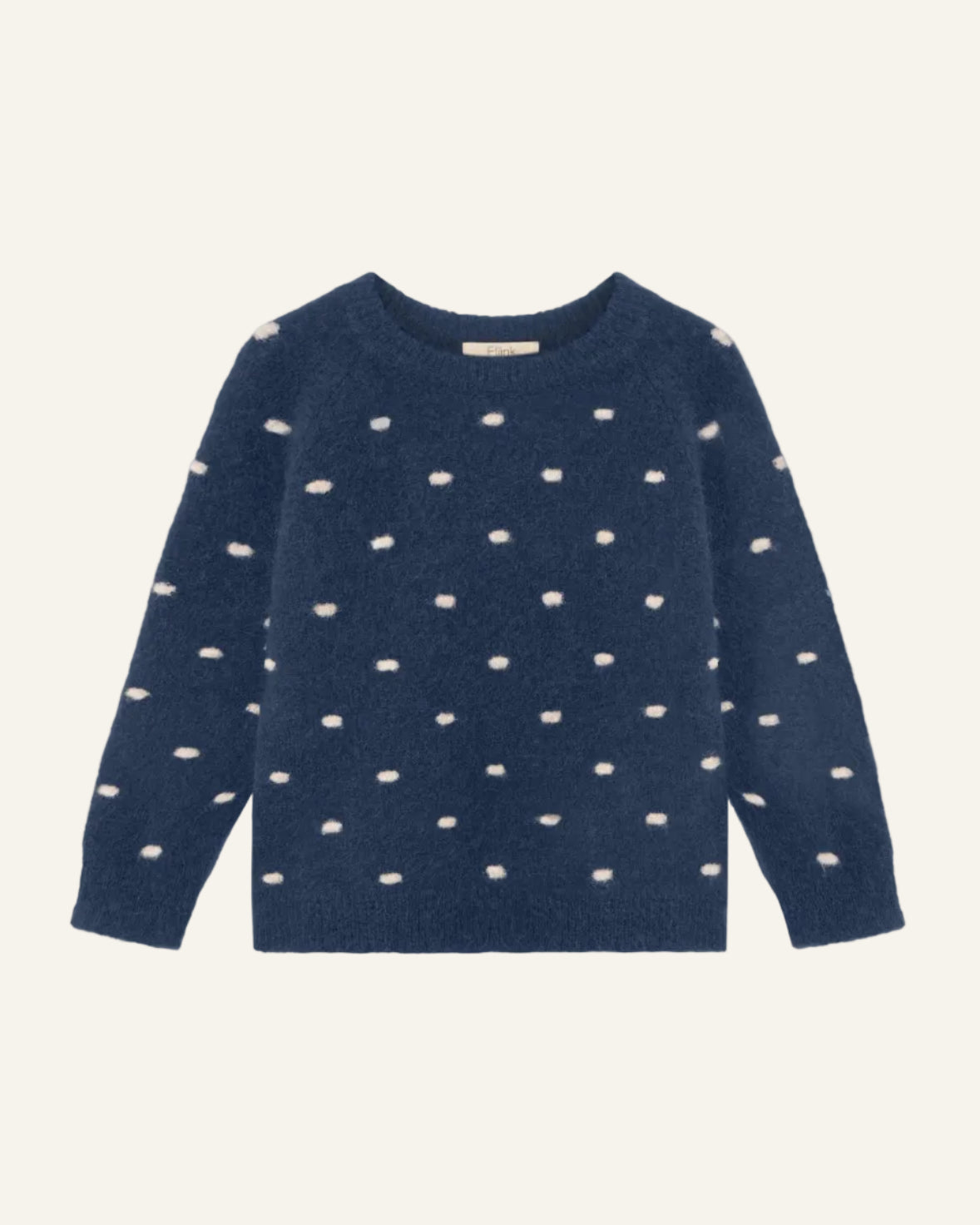 A navy blue knit sweater with a pattern of small, irregular cream-colored spots, displayed flat against a light gray background.