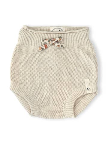 A pair of cream-colored, textured knit baby bloomers with a small floral bow detail on the front waistband, shown against a plain white background.