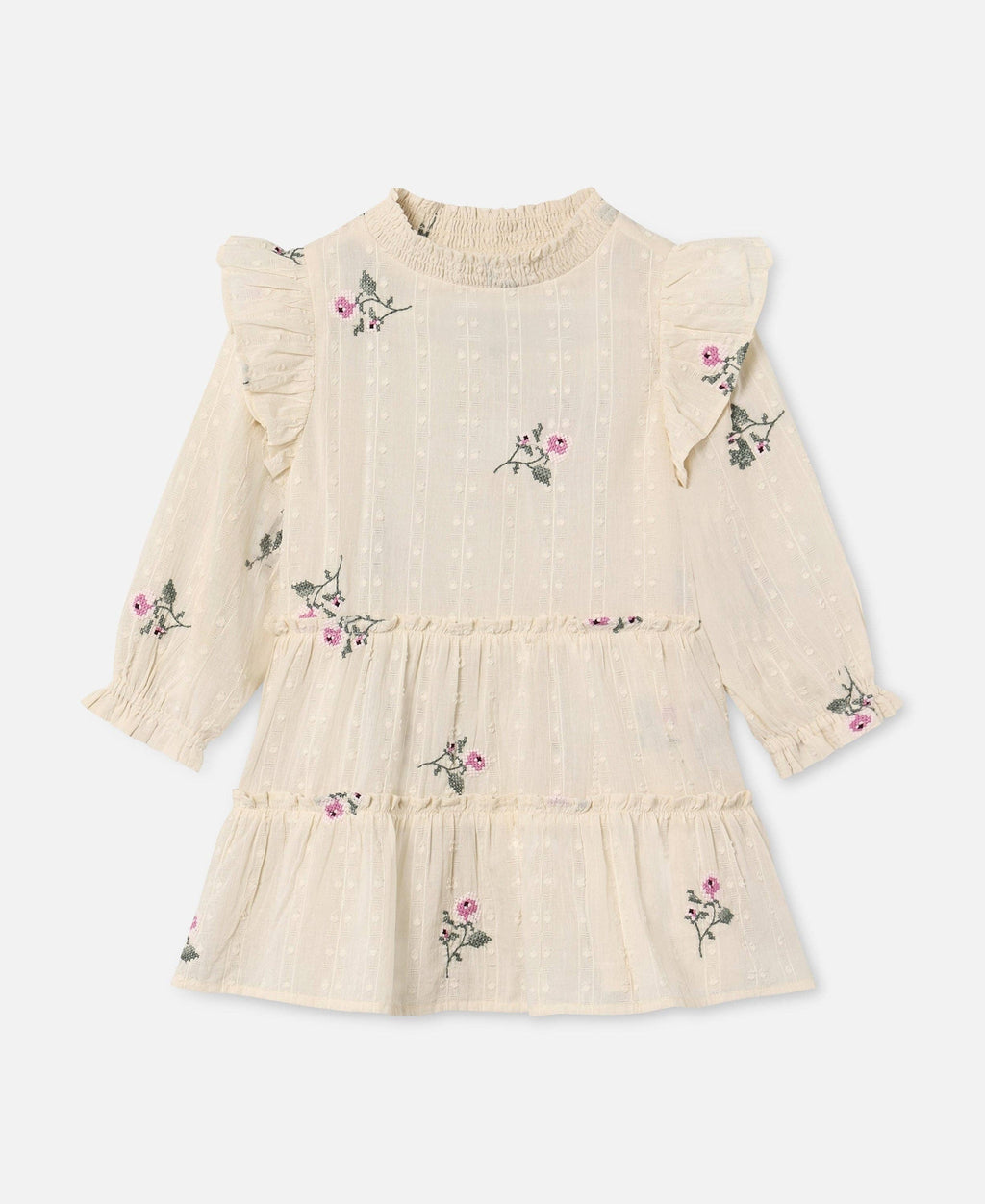 A cream-colored long-sleeve baby dress with ruffled shoulders, a smocked neck, and a tiered skirt, decorated with small pink and green floral prints.