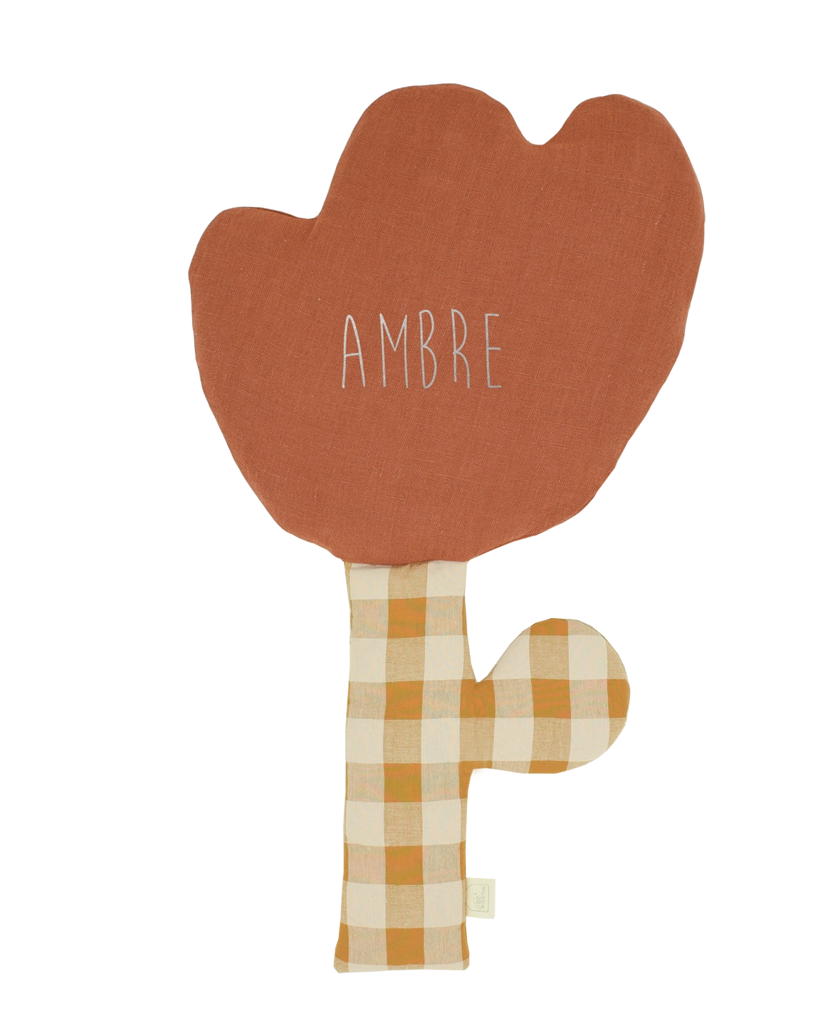 A fabric teething toy shaped like a cactus, featuring a terracotta orange top section with the word 'AMBRE' in white script, and a yellow-and-beige gingham-patterned stem and side bump, shown on a plain white background.