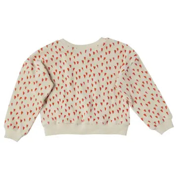 A cream-colored long-sleeve sweatshirt with a repeating pattern of small red hearts, shown from the back against a plain white background.