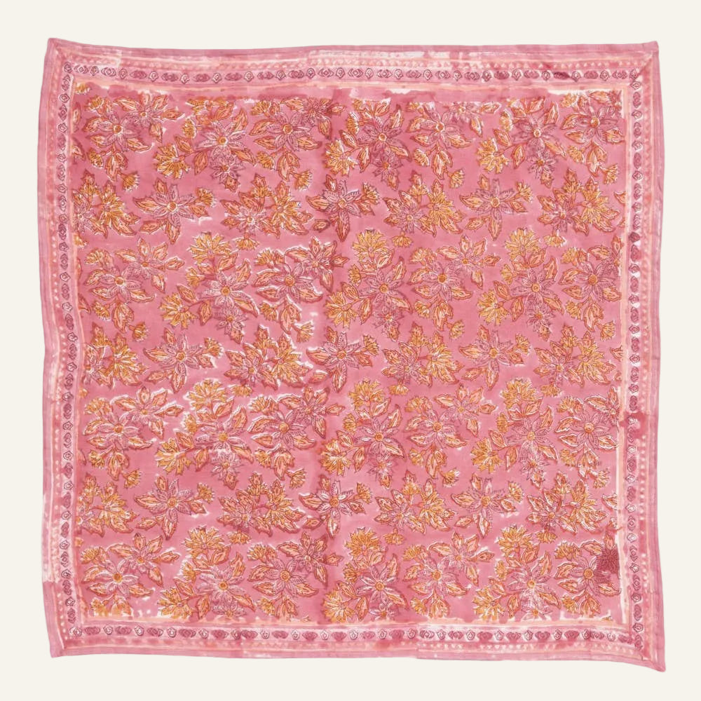 Pink fabric with gold floral pattern on a white background